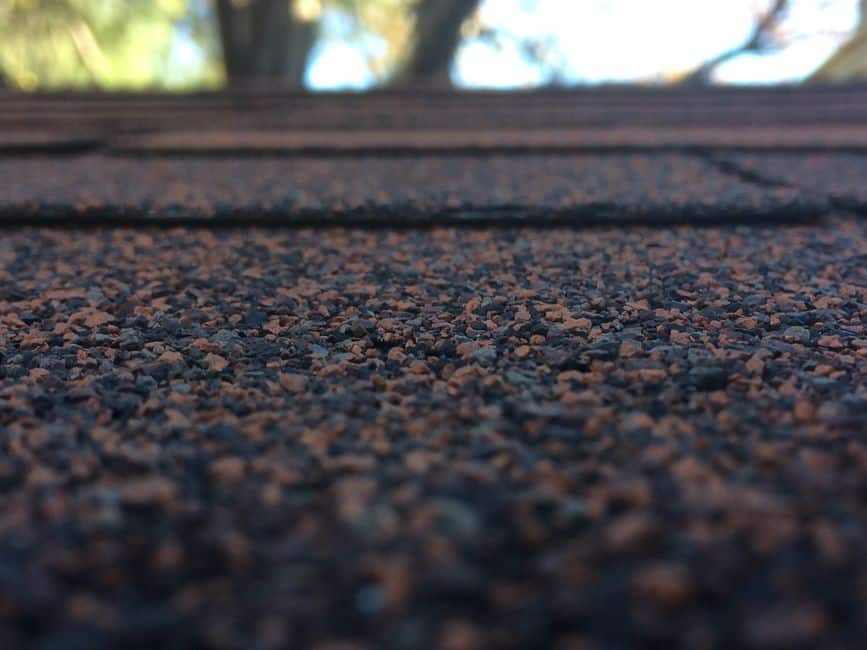 Close-up comparison of dark and light roof shingles