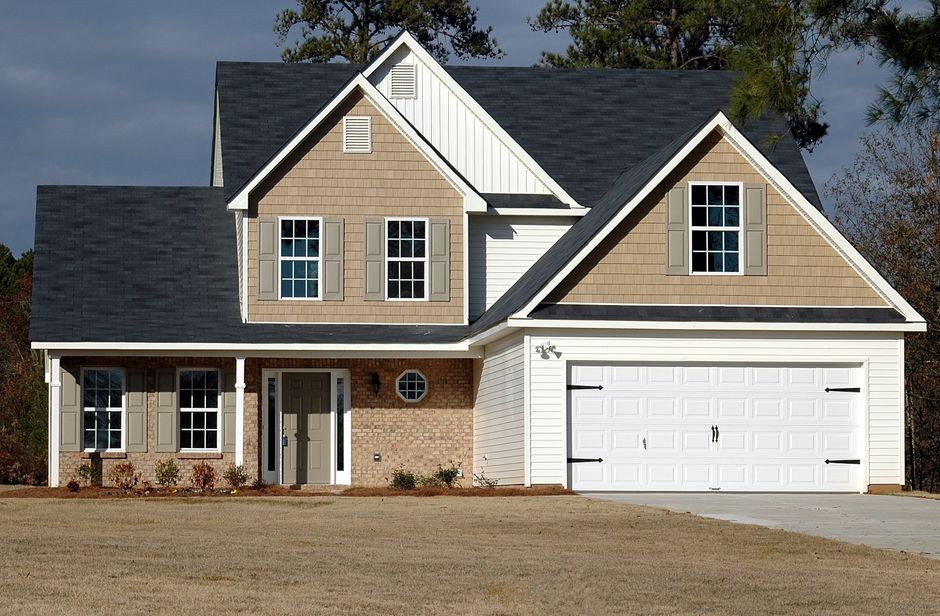 Real estate agent and buyers viewing a home with a new roof